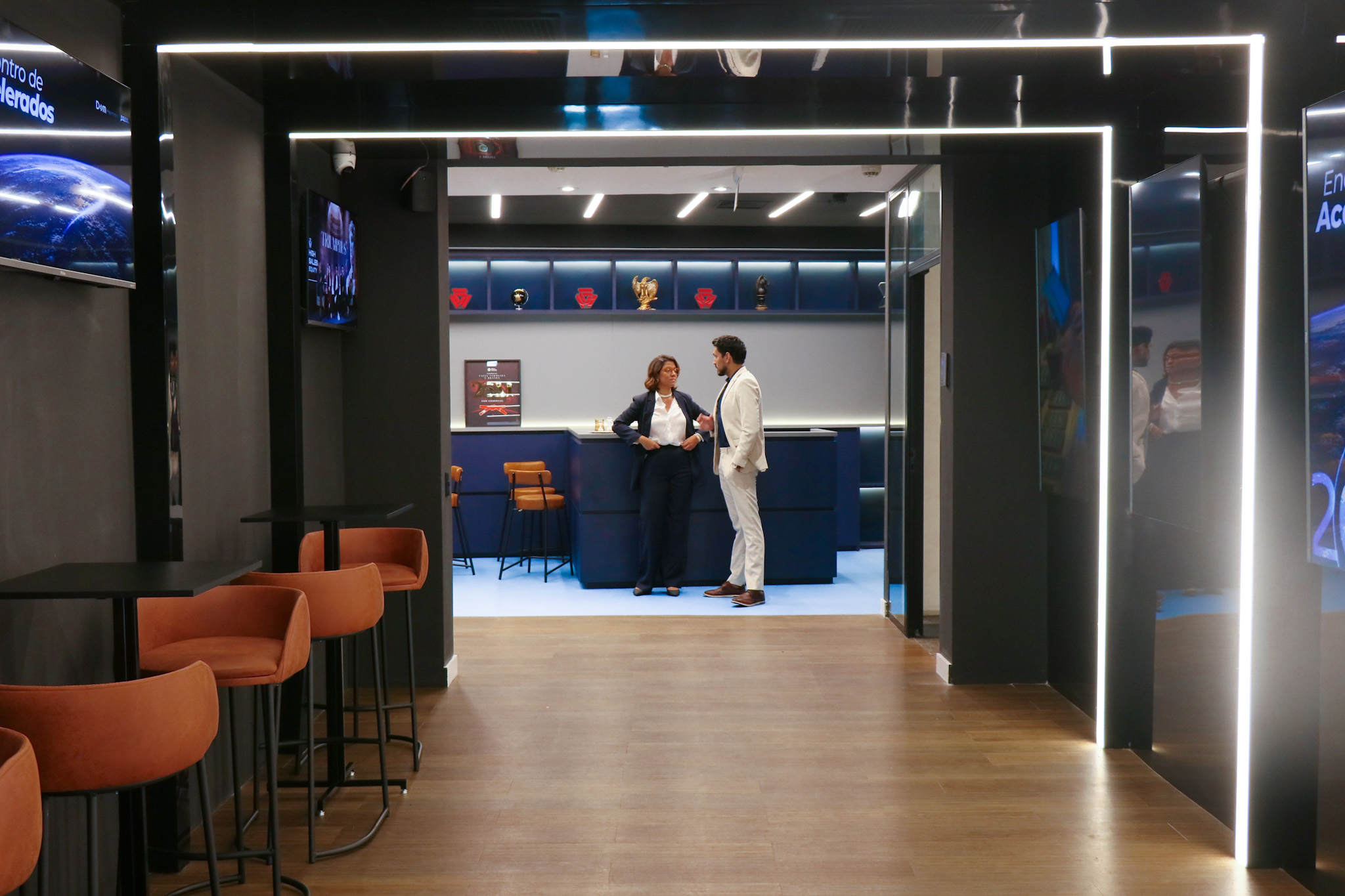 Hall de recepção integrado ao bar com mesas e cadeiras